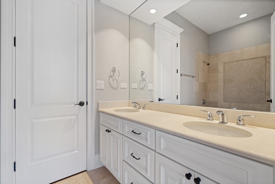 1904 West Wolfram Street Chicago, IL 60657 - Photo 36 of 56 a bathroom with double sink and a mirror