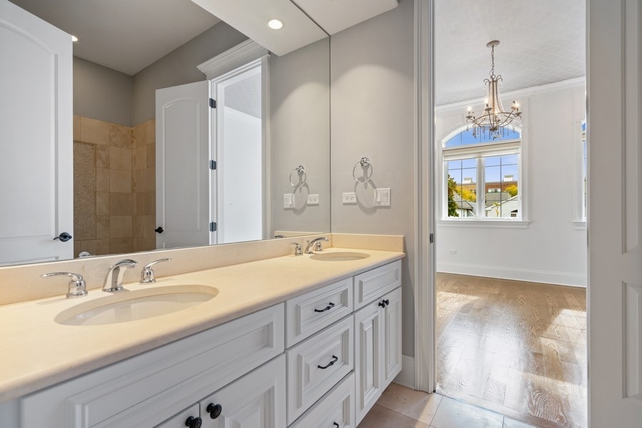 1904 West Wolfram Street Chicago, IL 60657 - Photo 38 of 56 a spacious bathroom with a granite countertop sink mirror and a bathtub