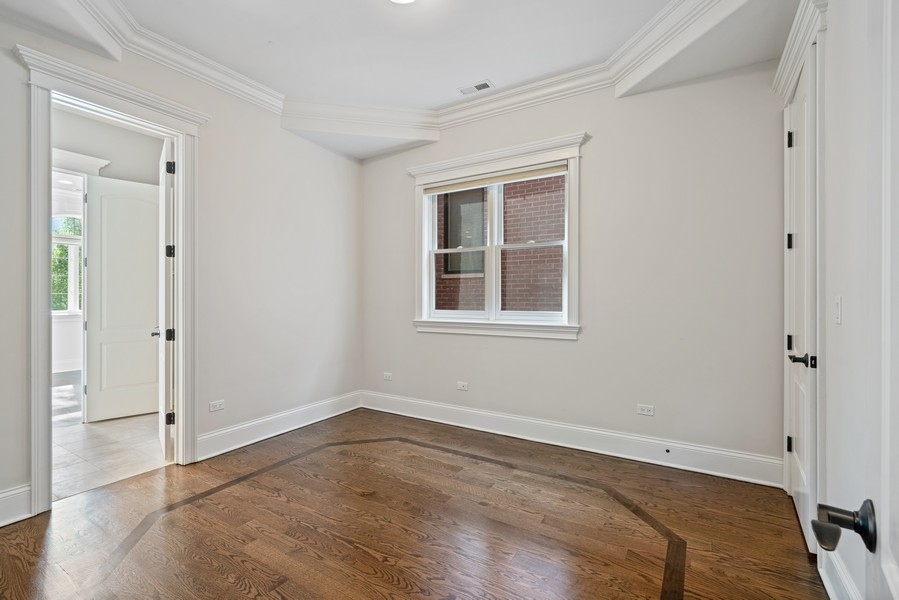 1904 West Wolfram Street Chicago, IL 60657 - Photo 39 of 56 a view of empty room with wooden floor and fan