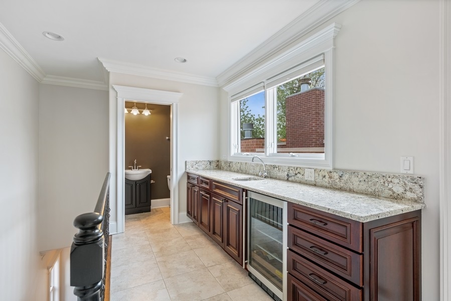 1904 West Wolfram Street Chicago, IL 60657 - Photo 49 of 56 a bathroom with a granite countertop sink and a mirror
