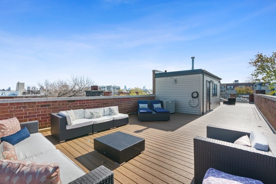 1904 West Wolfram Street Chicago, IL 60657 - Photo 51 of 56 a view of roof deck with couches and wooden floor