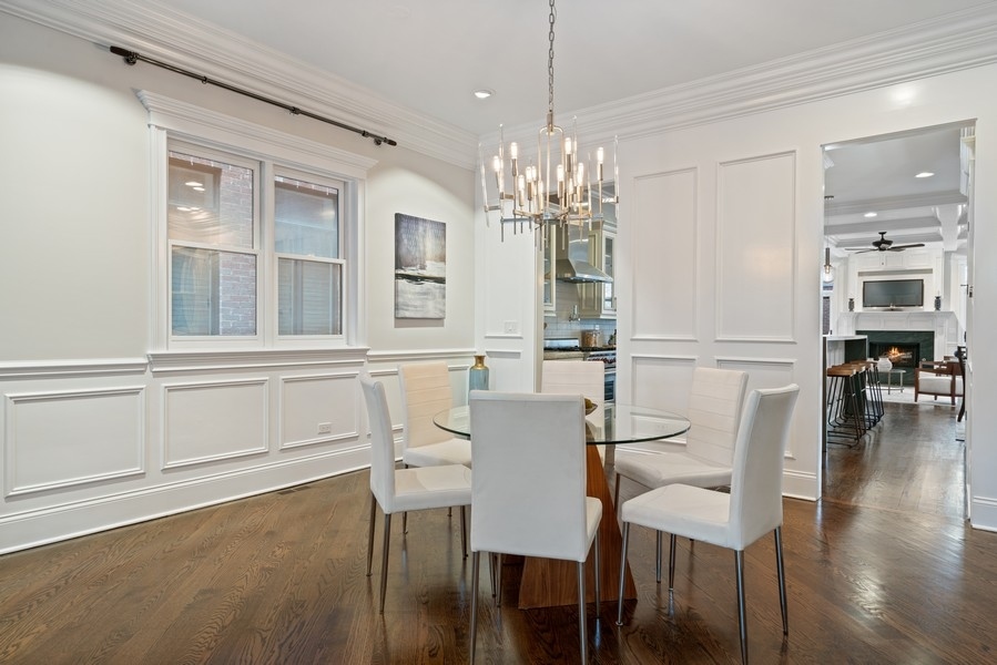 1904 West Wolfram Street Chicago, IL 60657 - Photo 8 of 56 a view of a dining room with furniture a chandelier and wooden floor