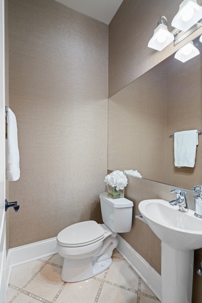 1904 West Wolfram Street Chicago, IL 60657 - Photo 9 of 56 a bathroom with a toilet a sink and mirror