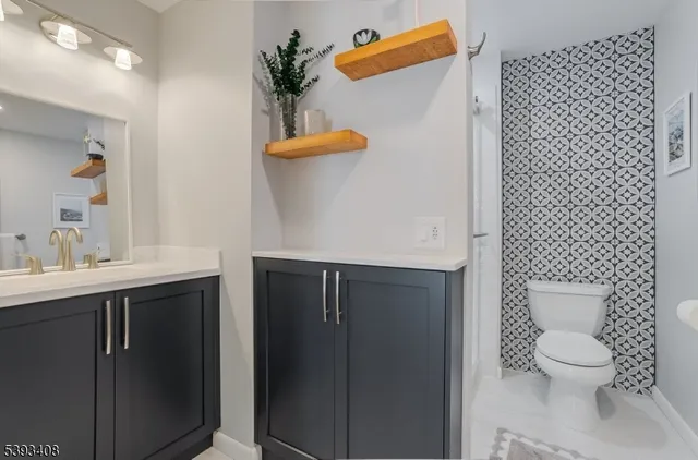 a bathroom with a sink a toilet and mirror