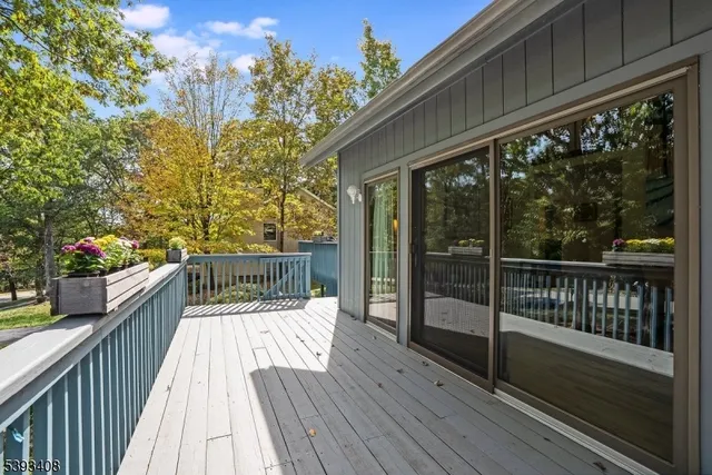 a balcony with wooden floor and wooden fence