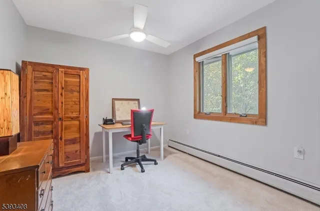 a view of a workspace with furniture and a window