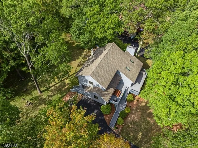 an aerial view of a house with a yard and trees