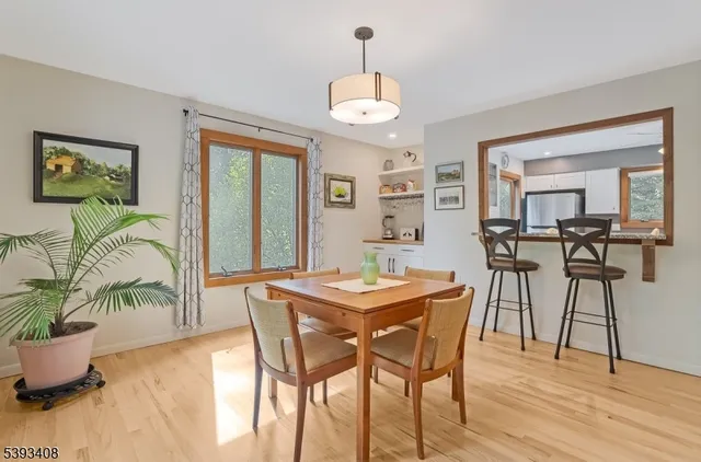 a dining room with furniture a chandelier and wooden floor