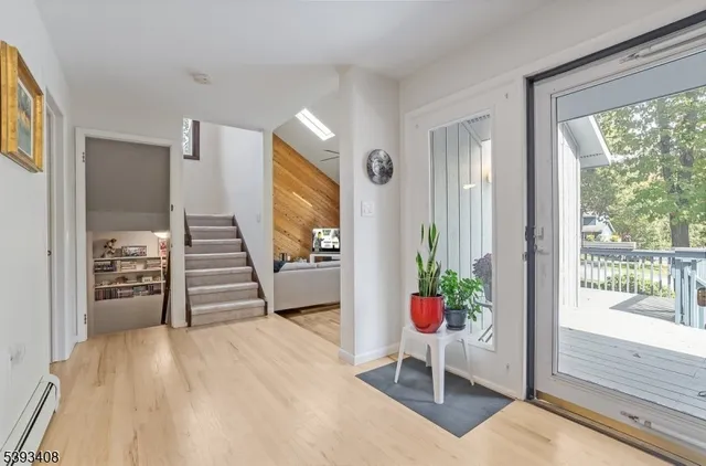 a view of a hallway with wooden floor and windows
