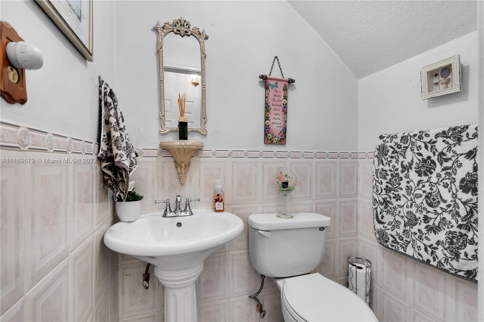 627 West 68th Street, Unit 627 Hialeah, FL 33014 - Photo 21 of 31 a bathroom with a toilet sink and mirror