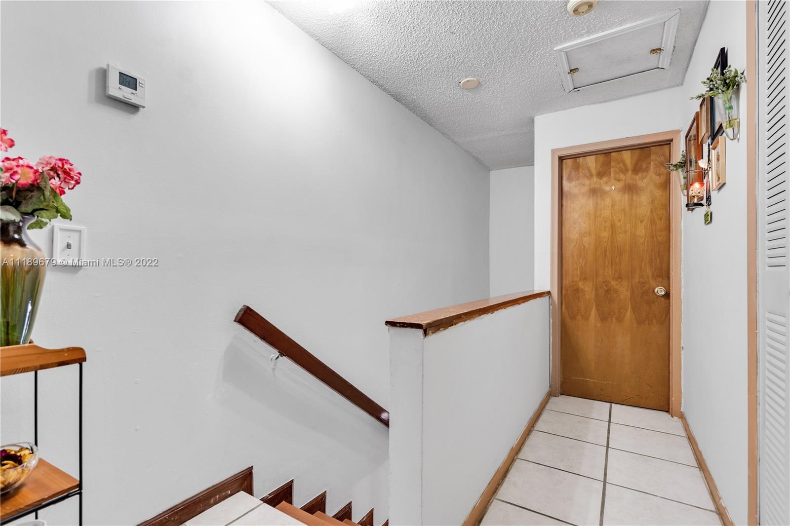 627 West 68th Street, Unit 627 Hialeah, FL 33014 - Photo 22 of 31 a view of hallway with stairs
