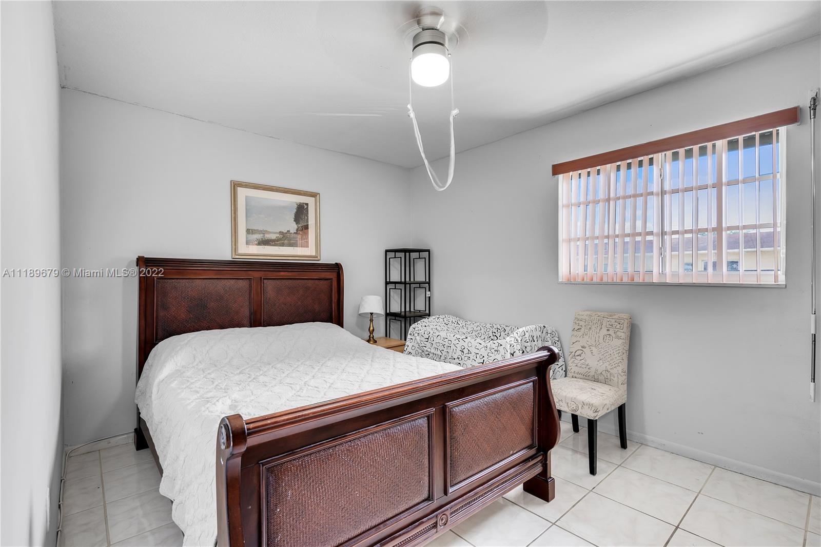 627 West 68th Street, Unit 627 Hialeah, FL 33014 - Photo 23 of 31 a bedroom with bed and window