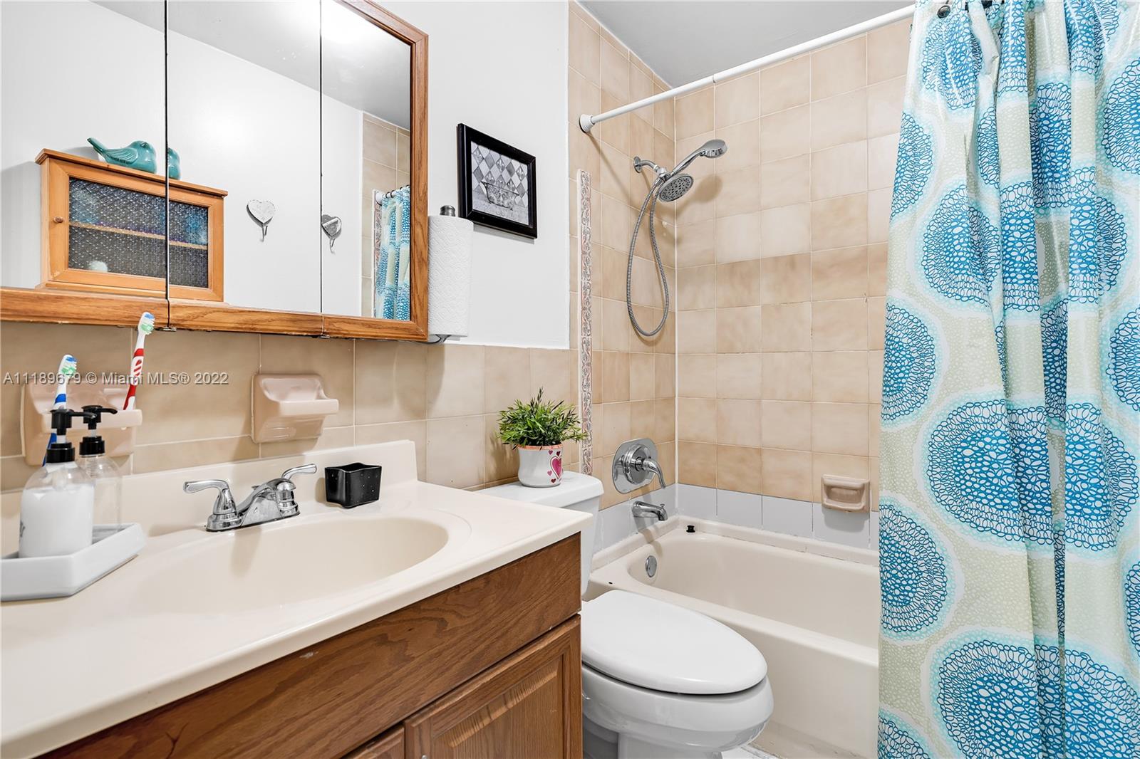 627 West 68th Street, Unit 627 Hialeah, FL 33014 - Photo 25 of 31 a bathroom with a sink a toilet and shower