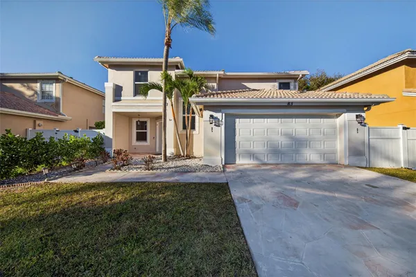 a front view of a house with yard and a garage