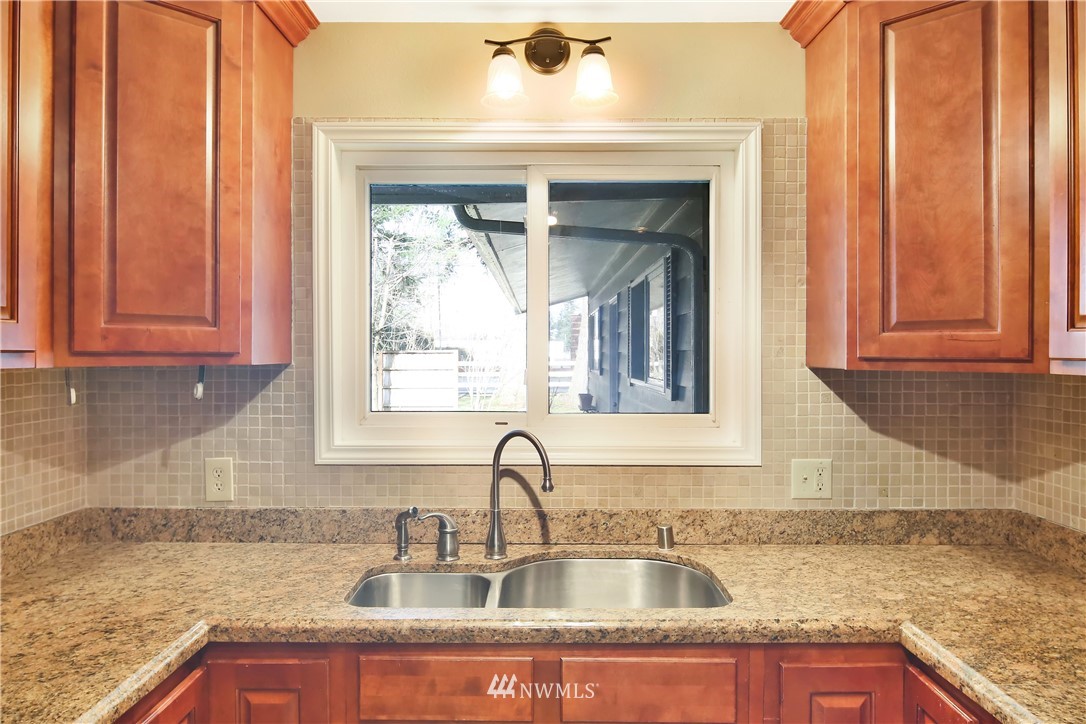 171 East Pole Road Lynden, WA 98264 - Photo 13 of 39 a kitchen with granite countertop a sink and cabinets