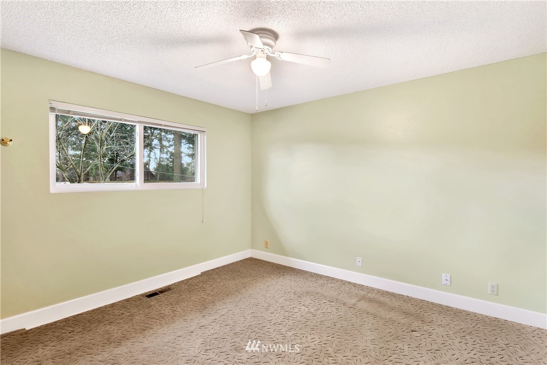 171 East Pole Road Lynden, WA 98264 - Photo 15 of 39 an empty room with a window and a chandelier fan