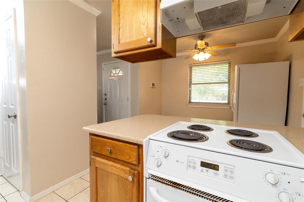 401 Berryhill Drive Springtown, TX 76082 - Photo 12 of 26 a kitchen with a stove a sink and a window