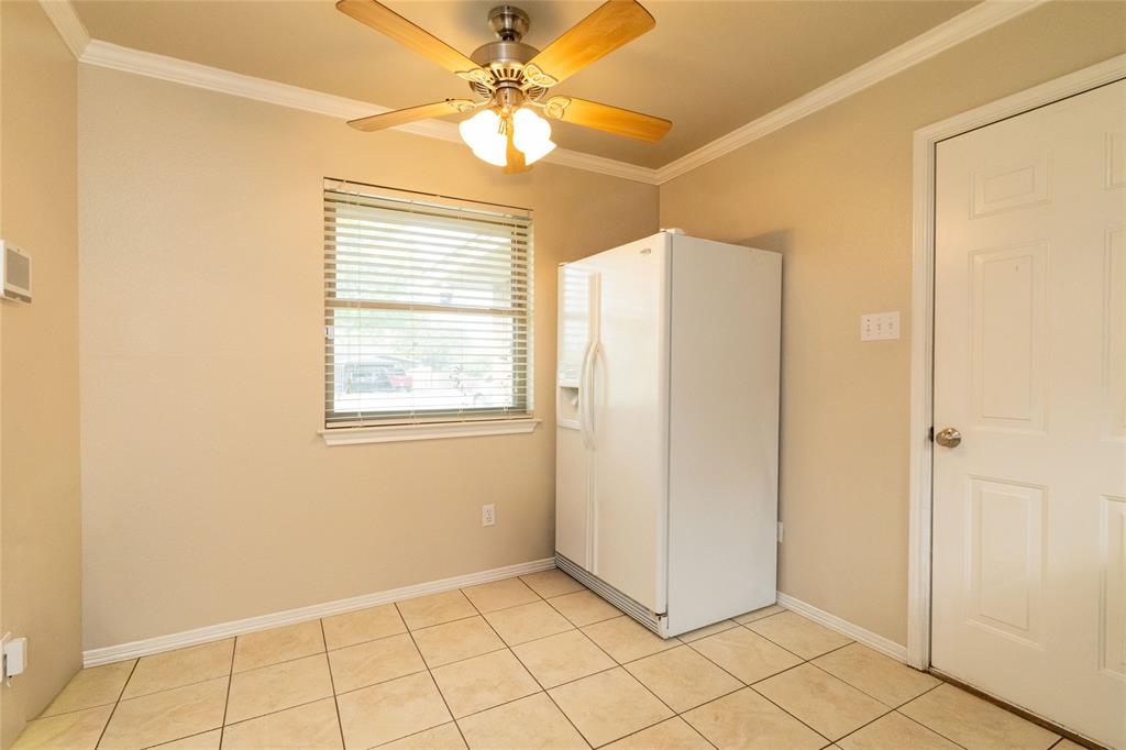 401 Berryhill Drive Springtown, TX 76082 - Photo 14 of 26 a view of an empty room with window and chandelier fan