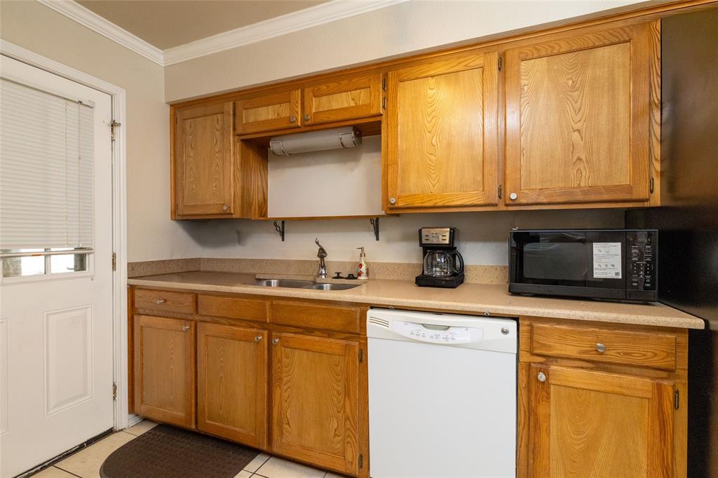 401 Berryhill Drive Springtown, TX 76082 - Photo 8 of 26 a kitchen with stainless steel appliances granite countertop a sink a stove and cabinets