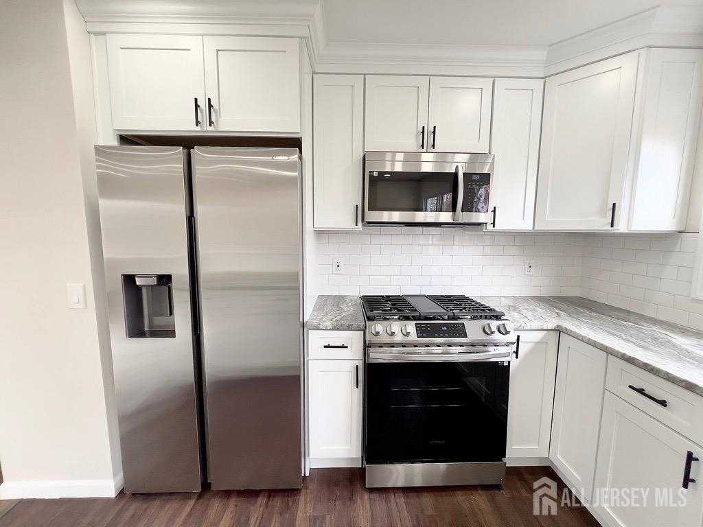 1273 Brookside Road Piscataway, NJ 08854 - Photo 15 of 33 a kitchen with cabinets stainless steel appliances and wooden floor