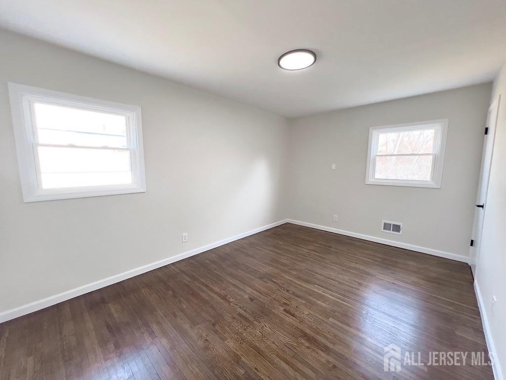 1273 Brookside Road Piscataway, NJ 08854 - Photo 18 of 33 an empty room with wooden floor and windows