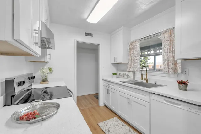 a kitchen with stainless steel appliances granite countertop a sink and cabinets