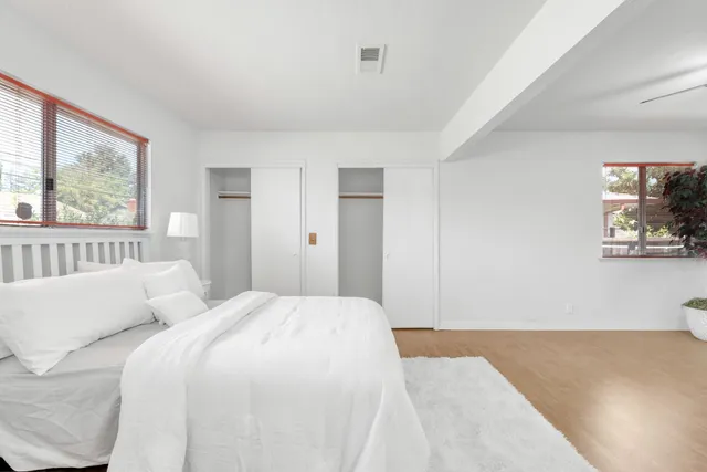 a bedroom with a large bed and a window