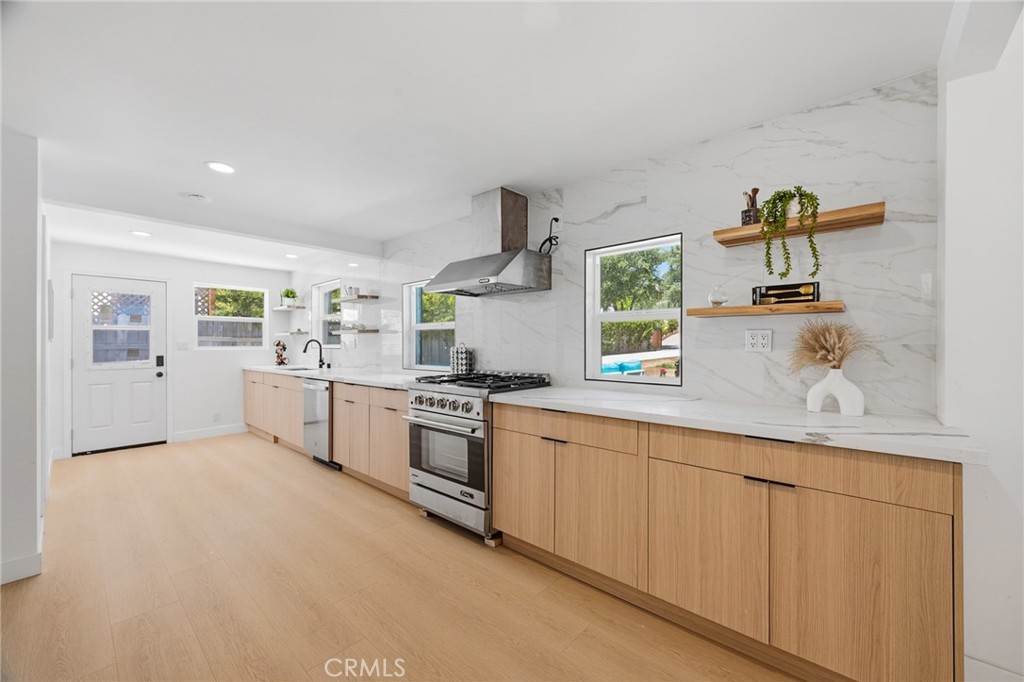 1280 East Woodbury Road Pasadena, CA 91104 - Photo 17 of 40 a kitchen with white cabinets and window