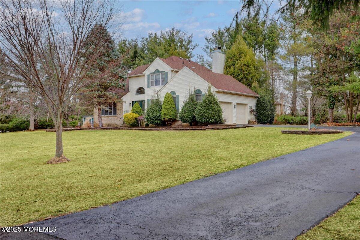a front view of house with yard and green space