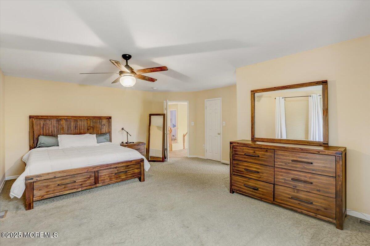 210 Hunt Road Freehold, NJ 07728 - Photo 21 of 39 a bedroom with a bed and a ceiling fan