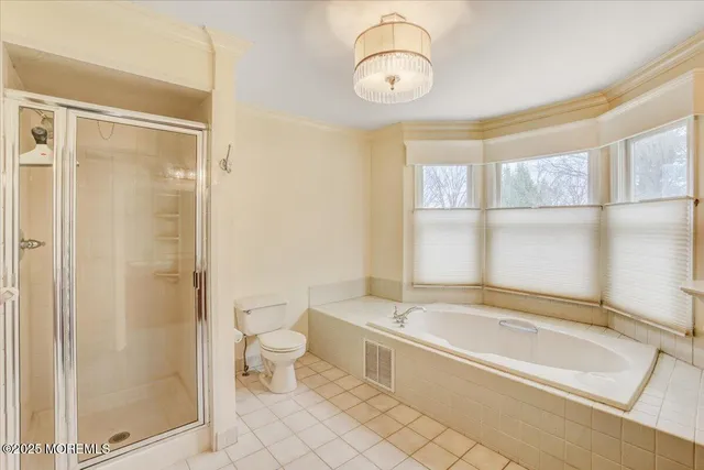 a spacious bathroom with a bathtub and a shower