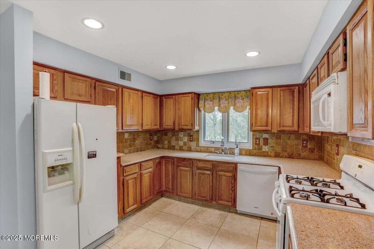 210 Hunt Road Freehold, NJ 07728 - Photo 27 of 39 a kitchen with a sink a refrigerator and window