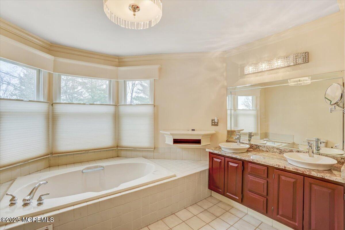 210 Hunt Road Freehold, NJ 07728 - Photo 35 of 39 a spacious bathroom with a tub sink and mirror