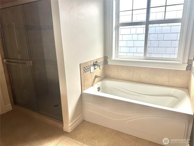 a bathroom with bathtub and window