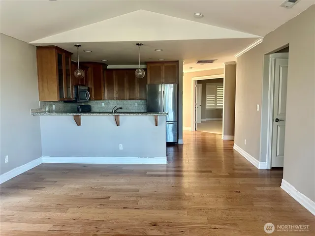 a view of a room with wooden floor and staircase