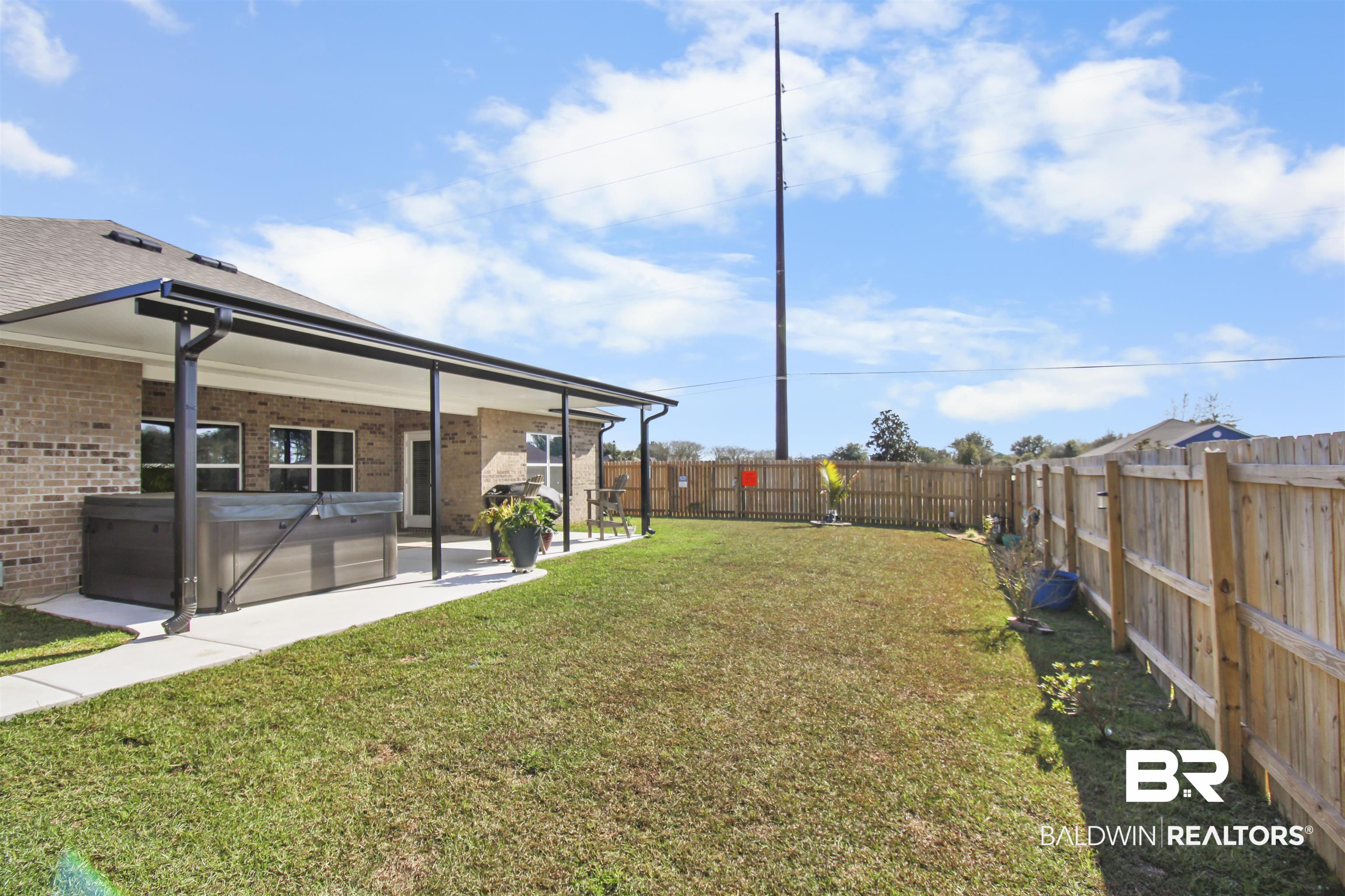 12523 Pheasant Run Elberta, AL 36530 - Photo 36 of 43 Fenced backyard with a hot tub and a patio