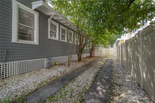a view of a patio with iron fence