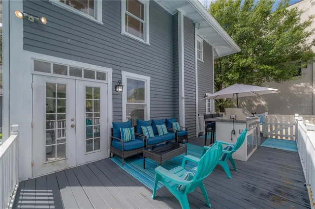 a view of a roof deck with furniture