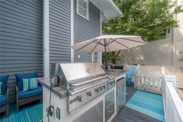 a view of a house with backyard and sitting area