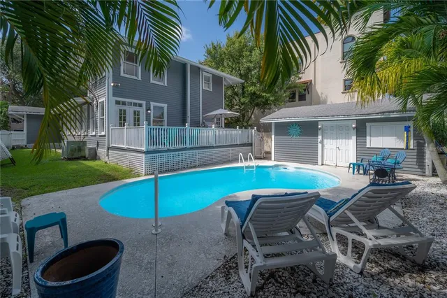 a table and chairs in patio of the house