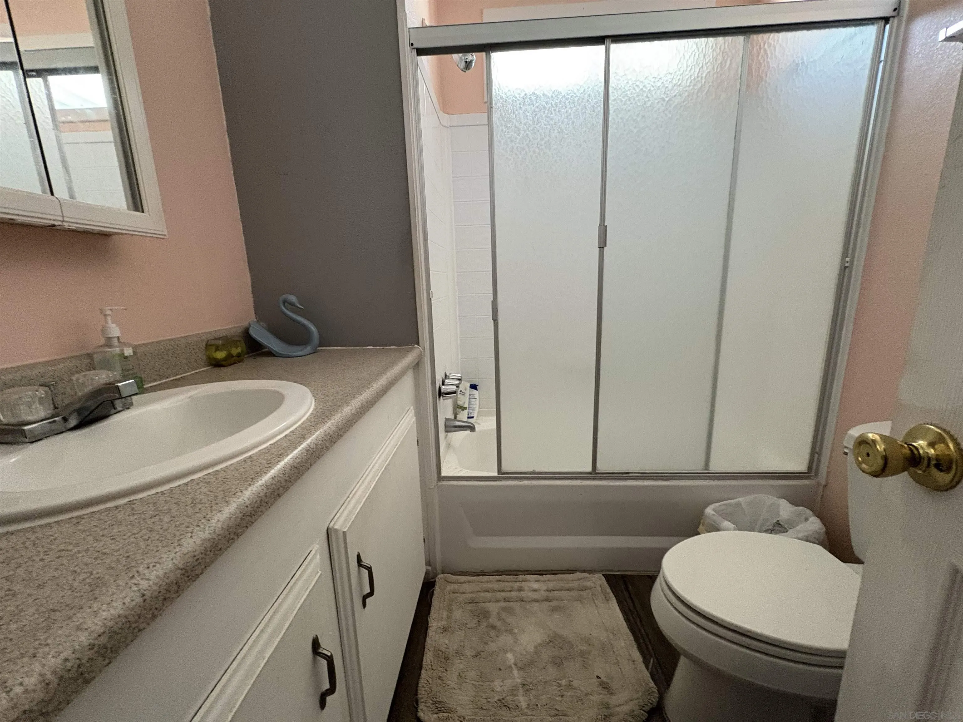 402 63rd Street, Unit 99 San Diego, CA 92114 - Photo 11 of 15 a bathroom with a granite countertop sink toilet and mirror