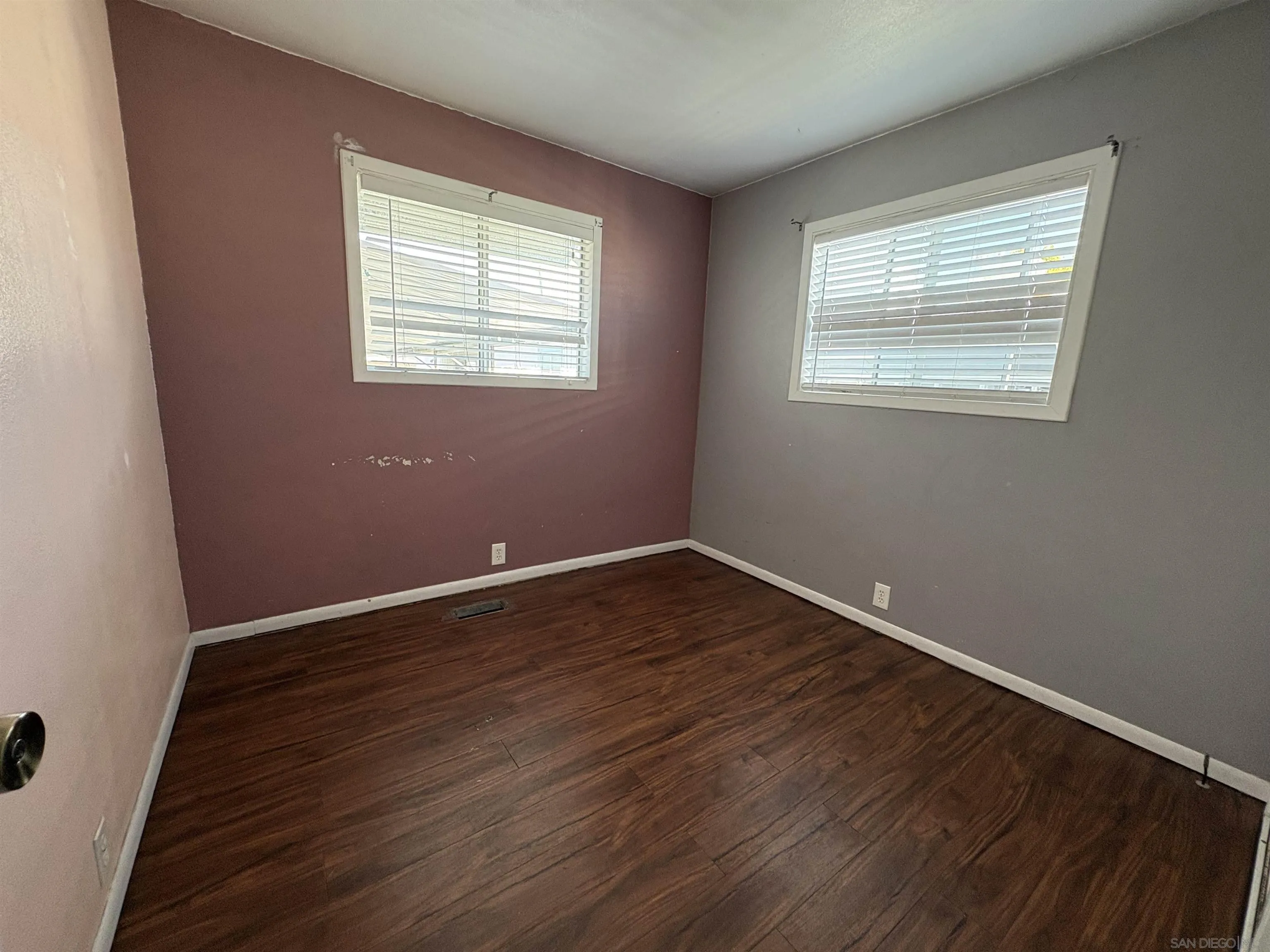 402 63rd Street, Unit 99 San Diego, CA 92114 - Photo 12 of 15 a view of an empty room with wooden floor and a window