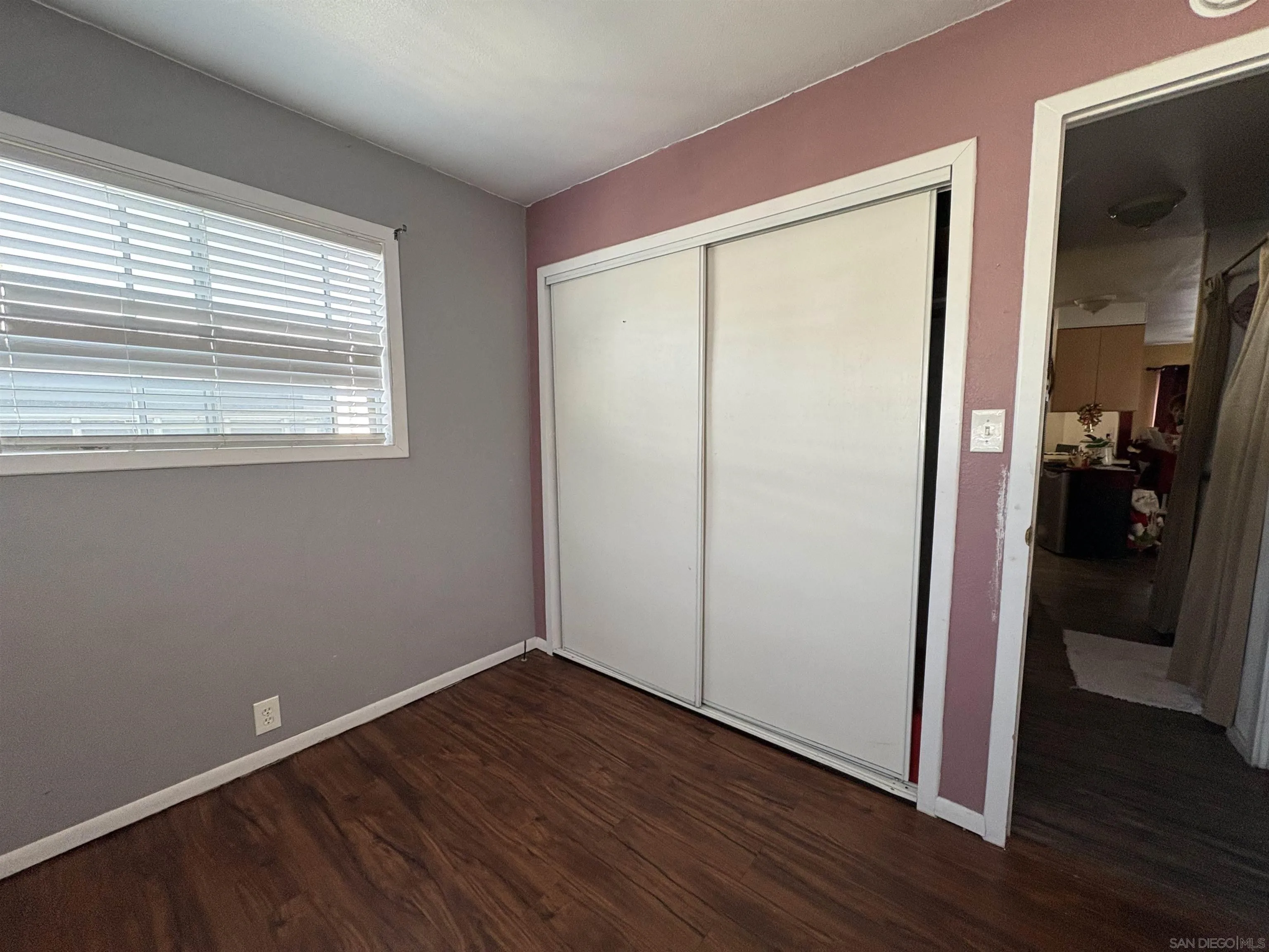402 63rd Street, Unit 99 San Diego, CA 92114 - Photo 13 of 15 an empty room with wooden floor and closet