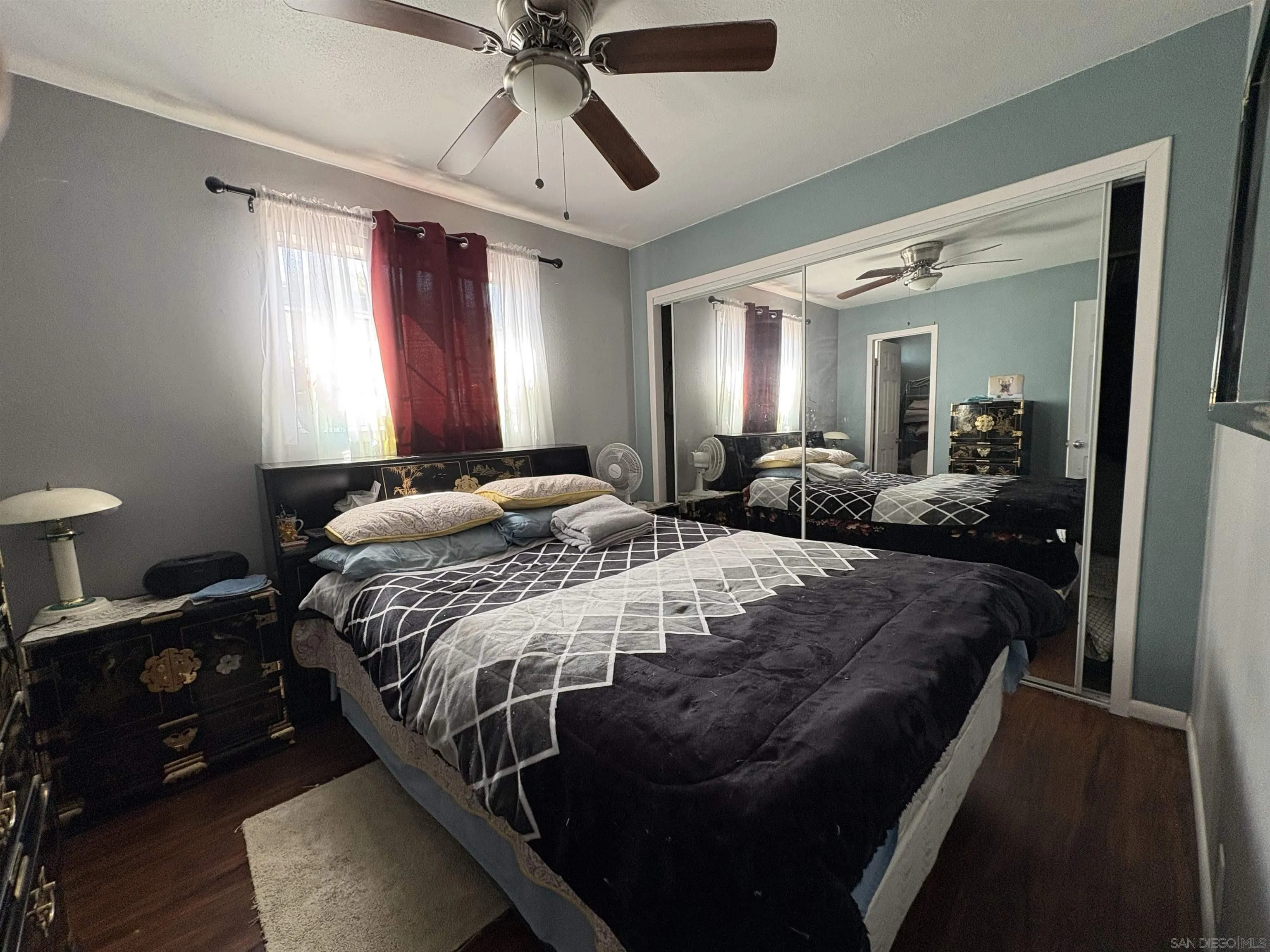 402 63rd Street, Unit 99 San Diego, CA 92114 - Photo 14 of 15 a bedroom with a bed a large mirror and furniture