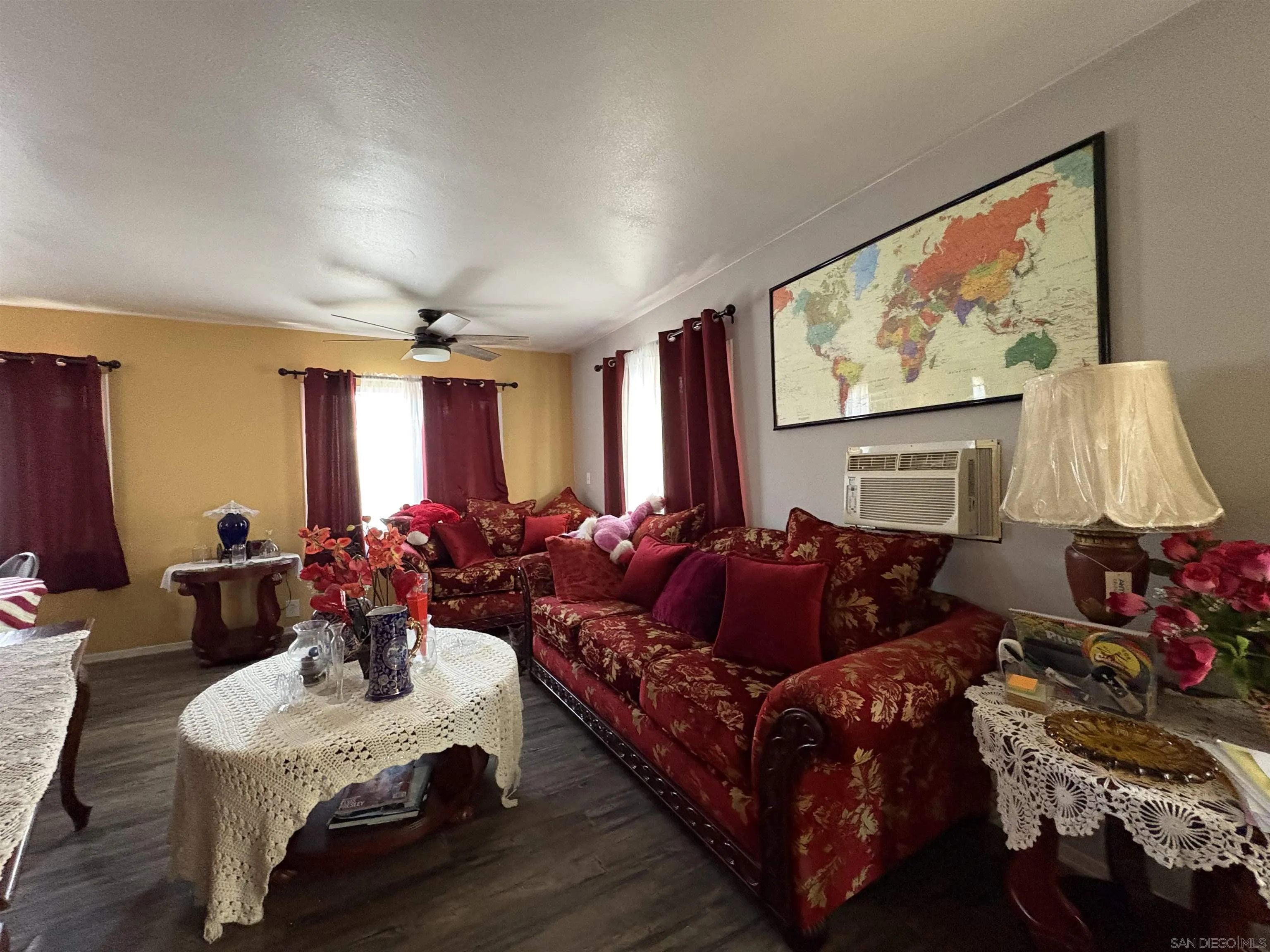 402 63rd Street, Unit 99 San Diego, CA 92114 - Photo 5 of 15 a living room with furniture a flat screen tv and a large window