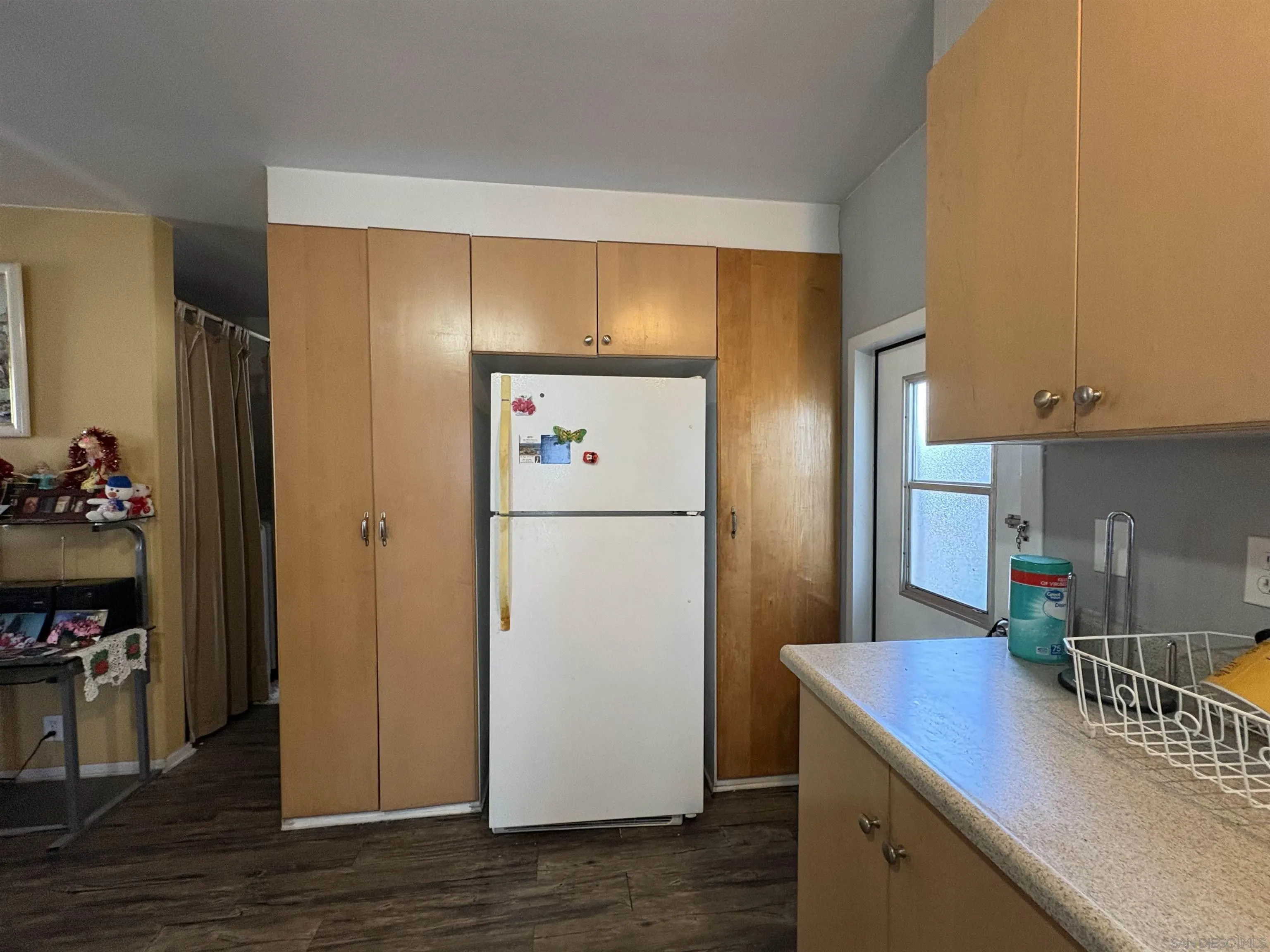 402 63rd Street, Unit 99 San Diego, CA 92114 - Photo 9 of 15 a kitchen with refrigerator and car