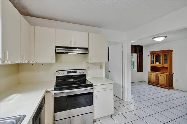 a kitchen with a refrigerator and cabinets