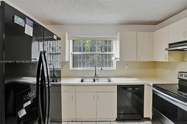 a kitchen with a stove and a sink