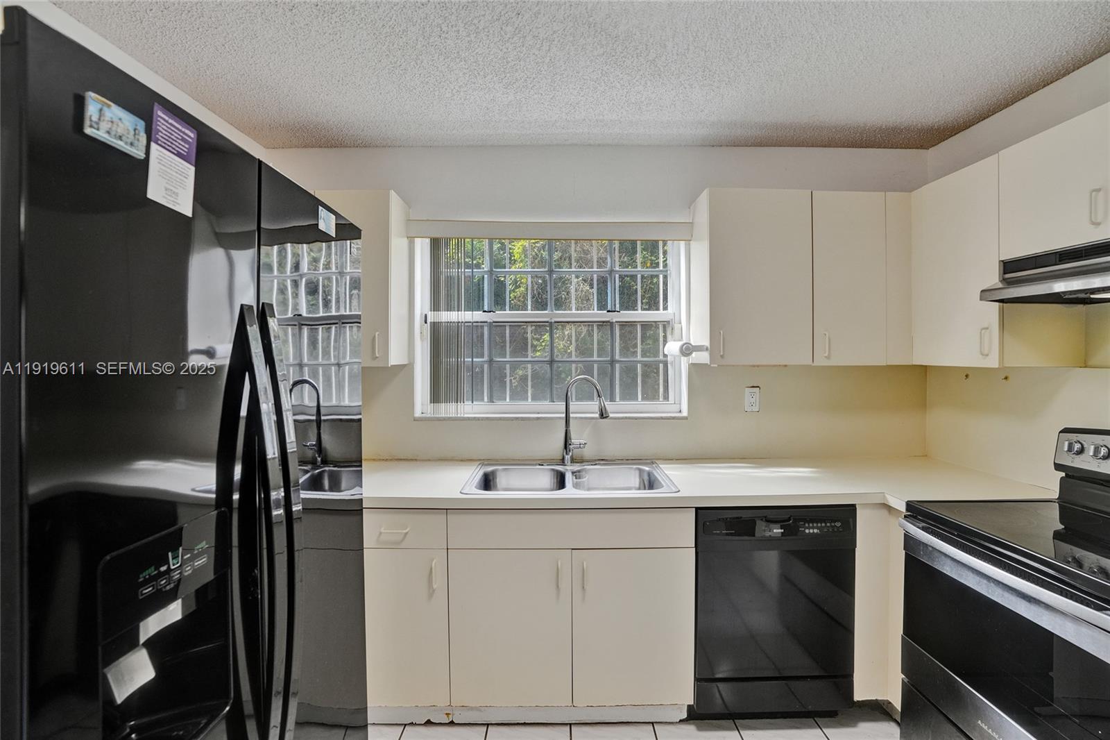 13401 Southwest 38th Street Miami, FL 33175 - Photo 17 of 45 a kitchen with a sink stove and cabinets