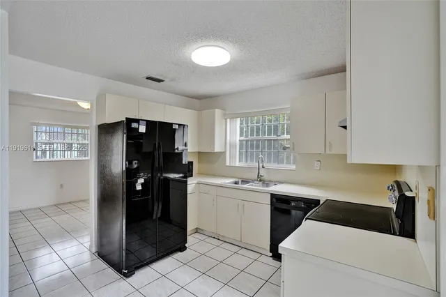 a kitchen with a refrigerator and microwave